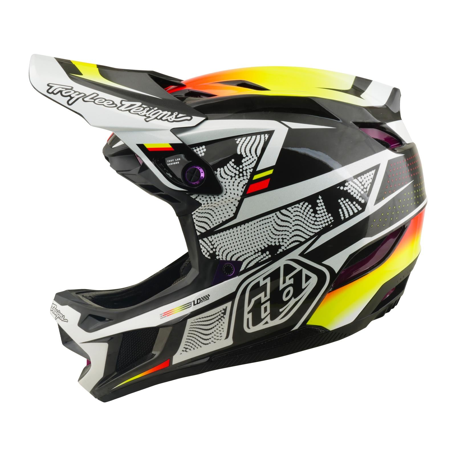 The TLD 26.1 D4 AS Carbon Helmet / Lined Up is a full-face Mips helmet for motocross or downhill MTB, featuring a black, white, yellow, and red geometric design with a visor, shown from the side.