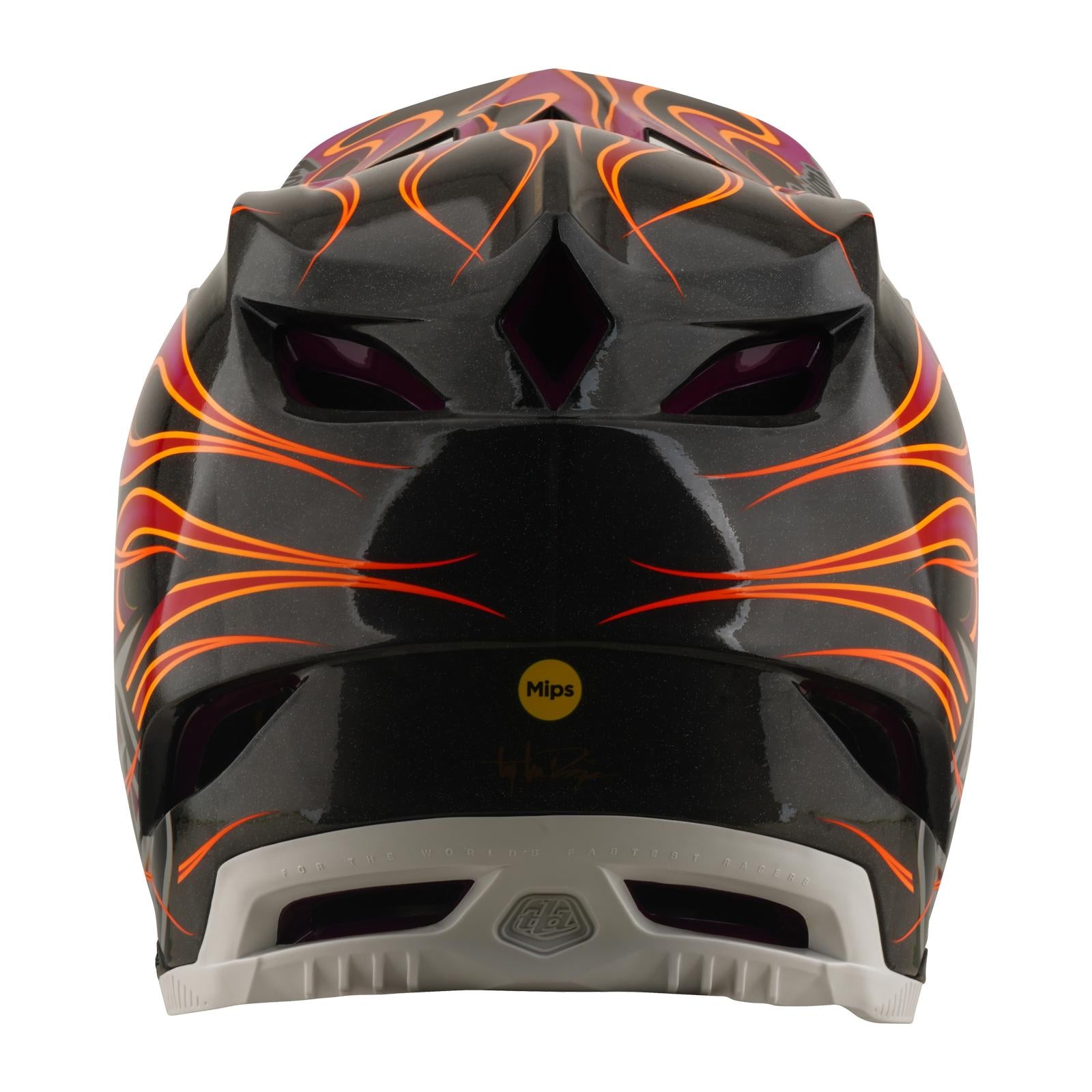 A rear view of the TLD 26.1 D4 AS Carbon Helmet in Torched Carbon/Magenta, featuring orange and yellow flame graphics, multiple vents, a Mips safety sticker, and a lightweight carbon fiber shell.