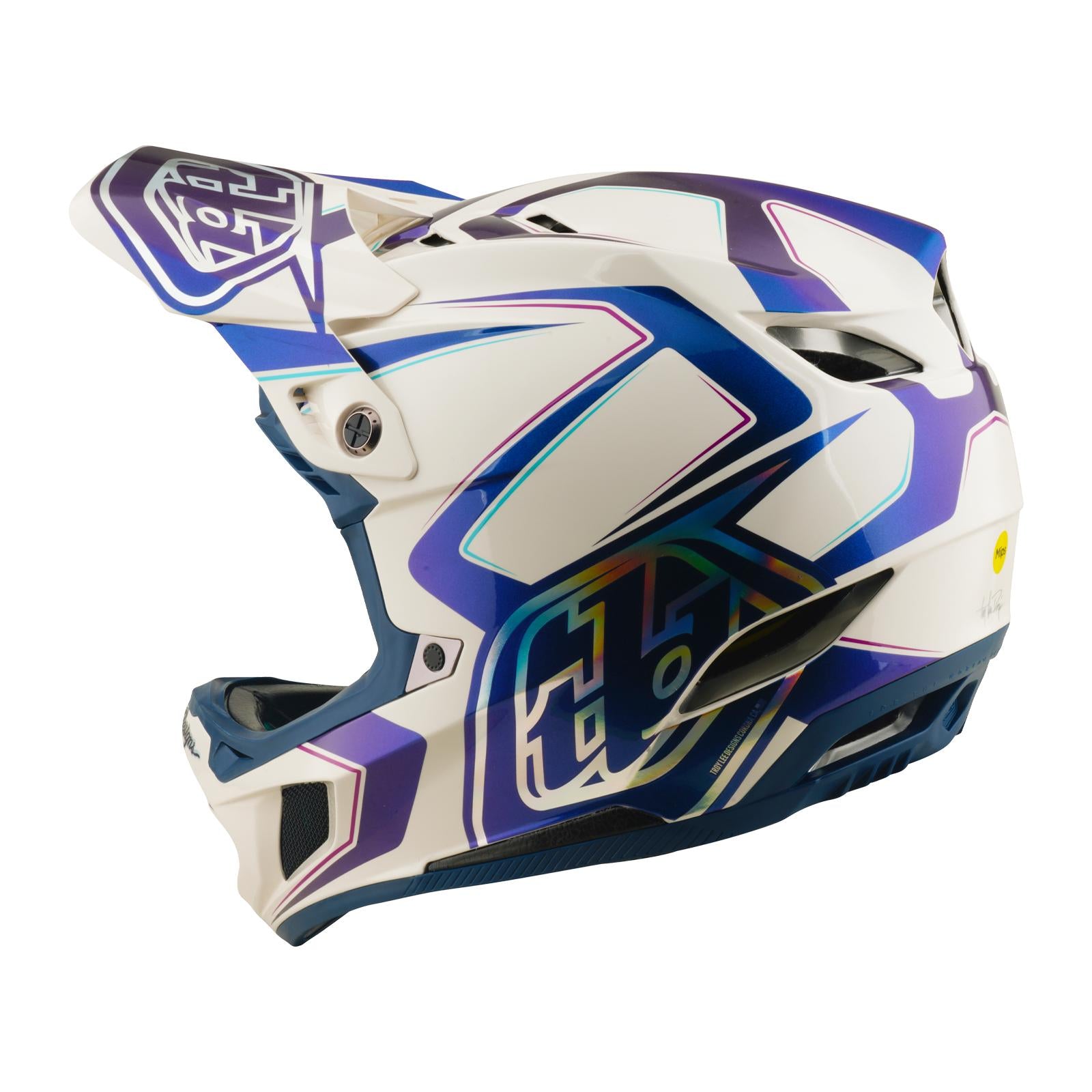 The TLD 26.1 D4 AS Composite Helmet in Flared White/Indigo features full-face coverage, purple geometric designs, Mips protection, and ventilation openings, displayed from the side on a plain background.