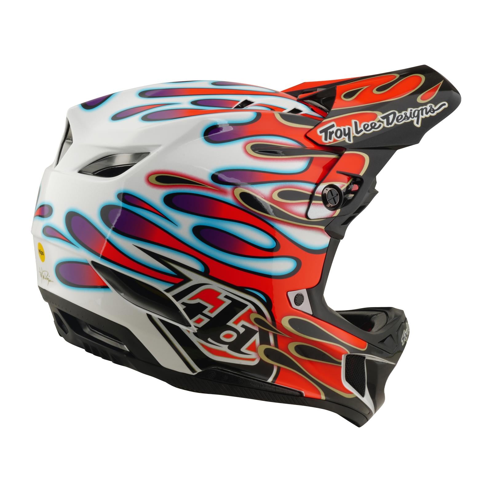 The TLD 26.1 D4 AS Composite Helmet in Overspray White/Red is a full-face BMX helmet with red, blue, and purple flame graphics, a Troy Lee Designs logo on the visor, and Mips protection for added safety.