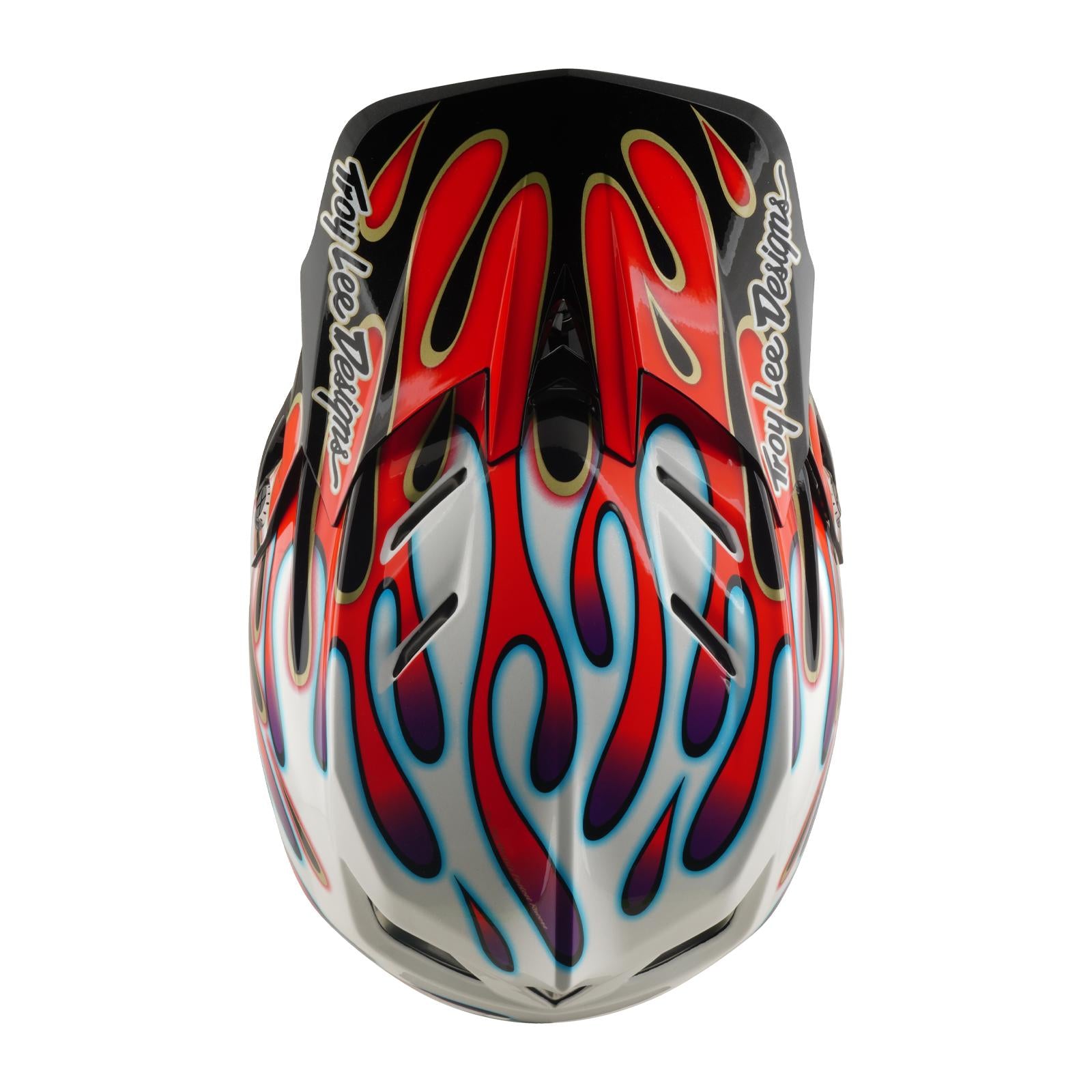 The TLD 26.1 D4 AS Composite Helmet in Overspray White/Red, viewed from above, boasts bold red and blue flames with "Troy Lee Designs" on each side and features Mips protection for enhanced safety and standout style.