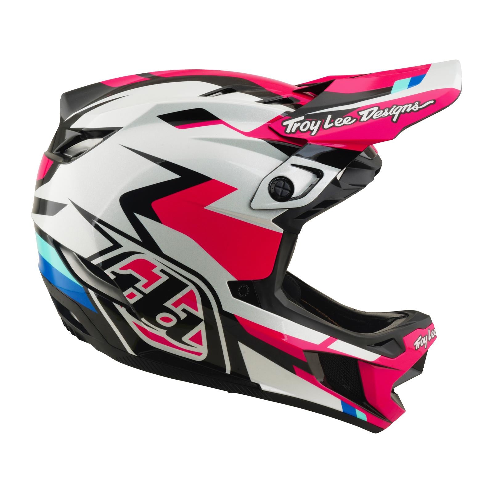 The TLD 26.1 D4 AS Polyacrylite Helmet / Roamer Magenta is a full-face helmet for motocross or mountain biking, featuring a white, pink, black, and blue geometric design, Troy Lee Designs logos, and Mips brain protection for safety.