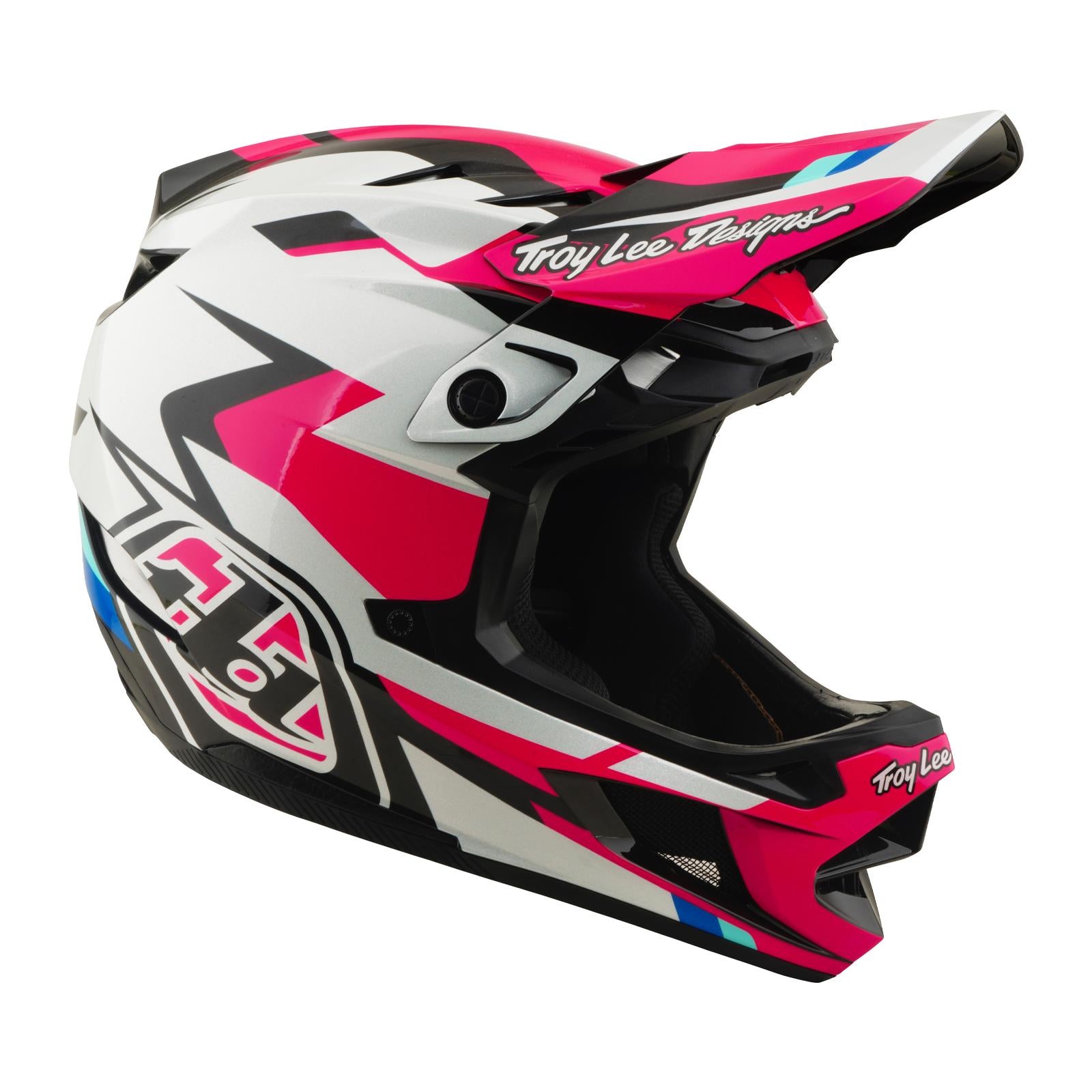 The TLD 26.1 D4 AS Polyacrylite Helmet / Roamer Magenta is a full-face helmet for motocross or mountain biking, featuring a pink, white, and black geometric design, Troy Lee Designs logos, and Mips brain protection for added safety.