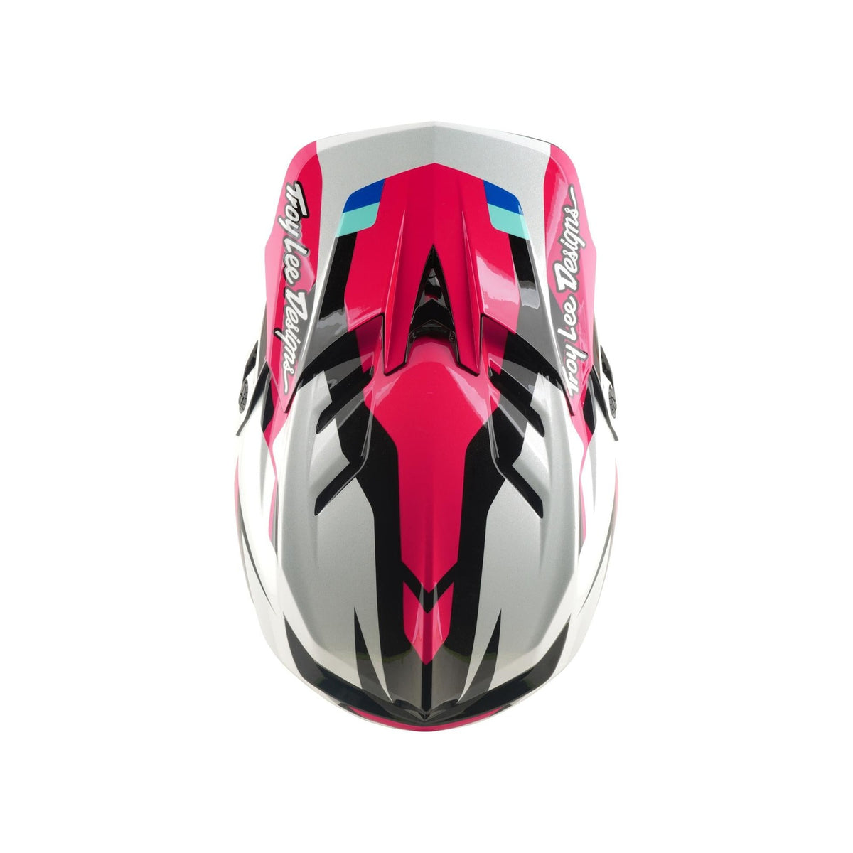 The TLD 26.1 D4 AS Polyacrylite Helmet / Roamer Magenta features a pink, black, white, and blue geometric design, ideal for mountain biking. Seen from the front, it showcases "Troy Lee Designs" branding on both sides.