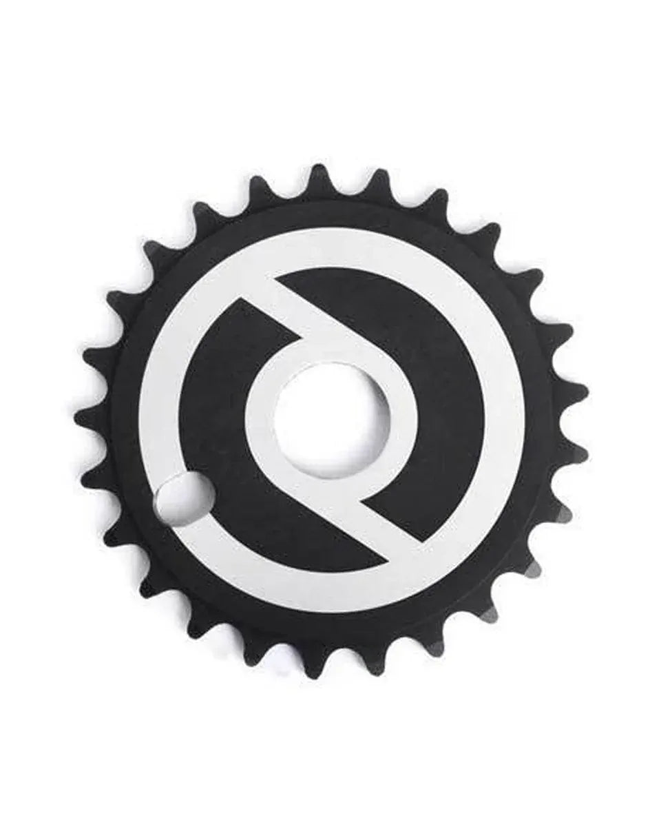 A black Primo Solid V2 Sprocket for BMX, CNC machined from durable aluminum and featuring a white, stylized circular graphic on its face, is centered against a plain white background.