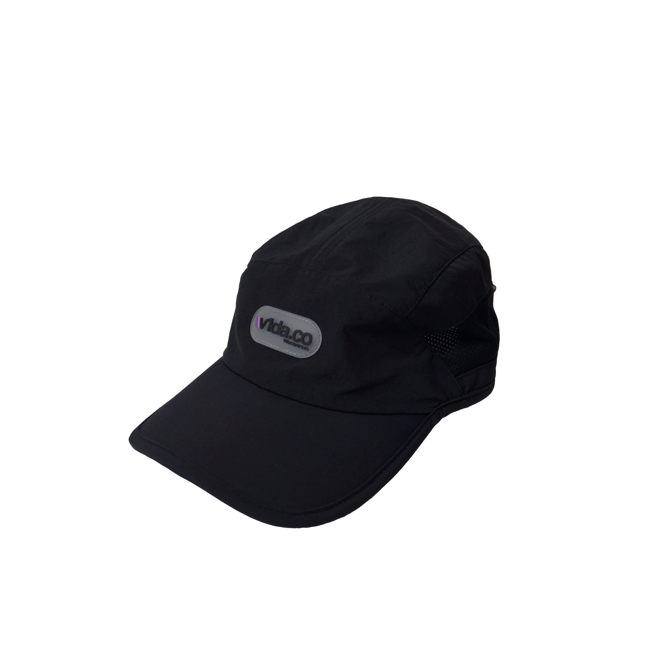 The V1da We Never Run Cap is a black nylon baseball cap with a curved brim, front "vindico" logo patch, and breathable panel for comfort.