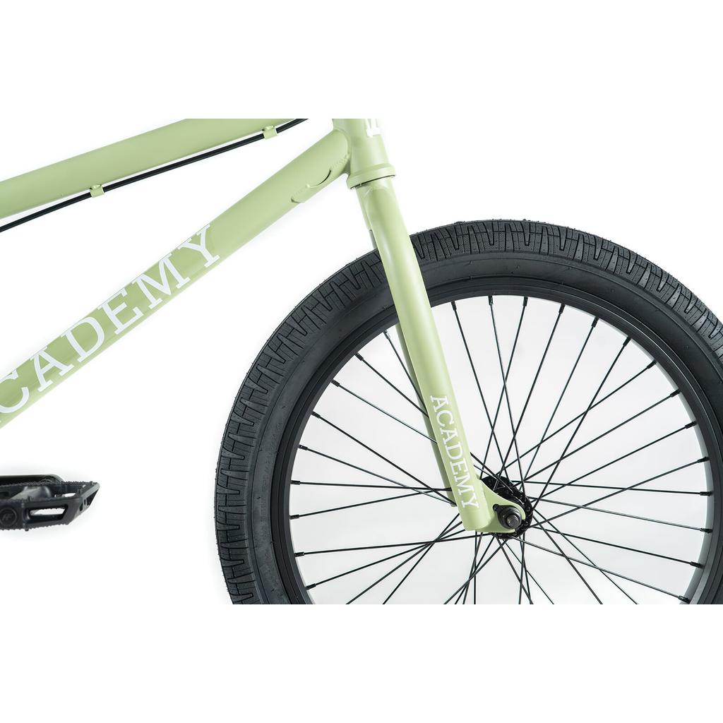 Close-up view of the Academy Aspire 20 Inch Bike’s light green frame and front wheel with CrMo bars, both showing “ACADEMY” branding, set against a white background.