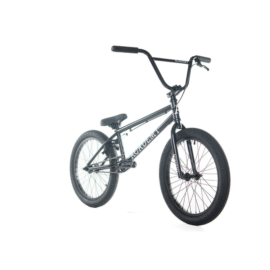 The Academy Entrant 20 Inch Bike, featuring a black BMX design with a high-rise handlebar, padded seat, and thick tires, is shown standing against a white background. Perfect for those new to the sport, it includes a sealed rear cassette hub for smooth performance.