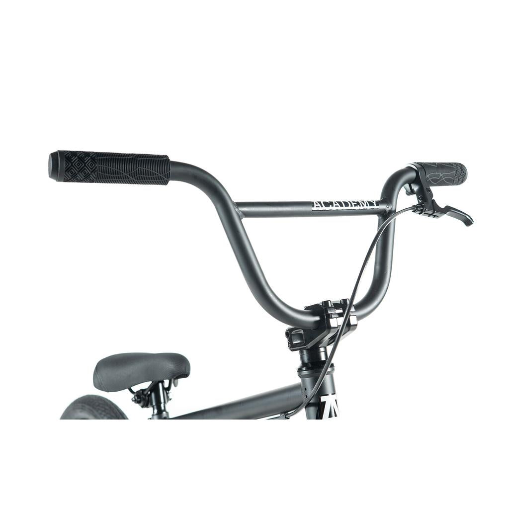 Close-up of the Academy Inspire 16 Inch Bike’s black handlebars, grips, brake lever, seat, and frame with double wall rims against a white background.