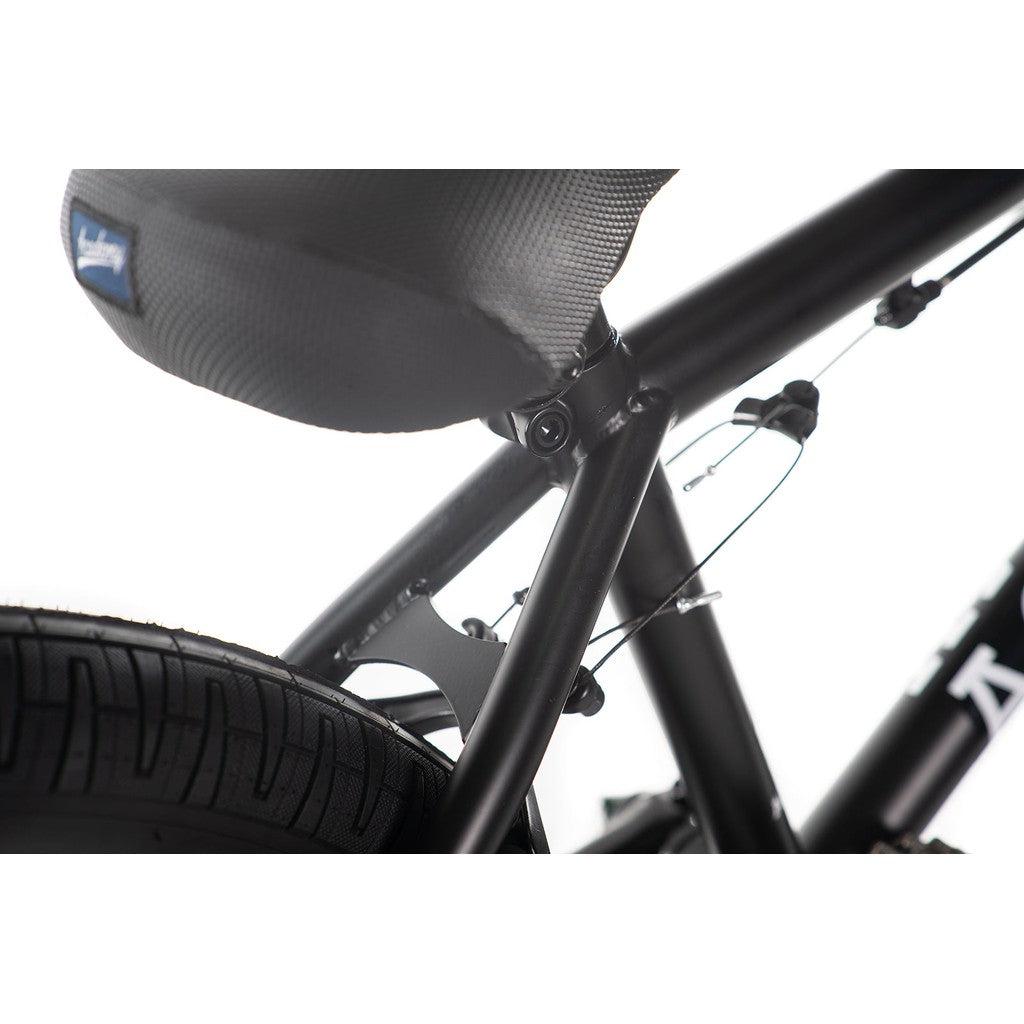 Close-up of the Academy Trooper 20 Inch Bike, a black BMX featuring a Hi-Ten steel frame, with the seat post, rear tire, and brake cables highlighted against a white background.