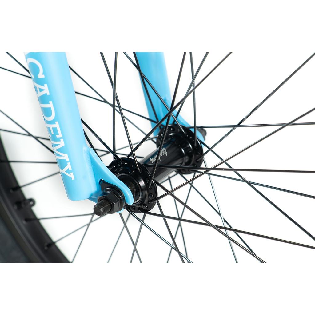Close-up of the Academy Trooper 20 Inch Bike front wheel showcasing black spokes, sealed hubs, and a blue fork with "ACADEMY" printed on it.