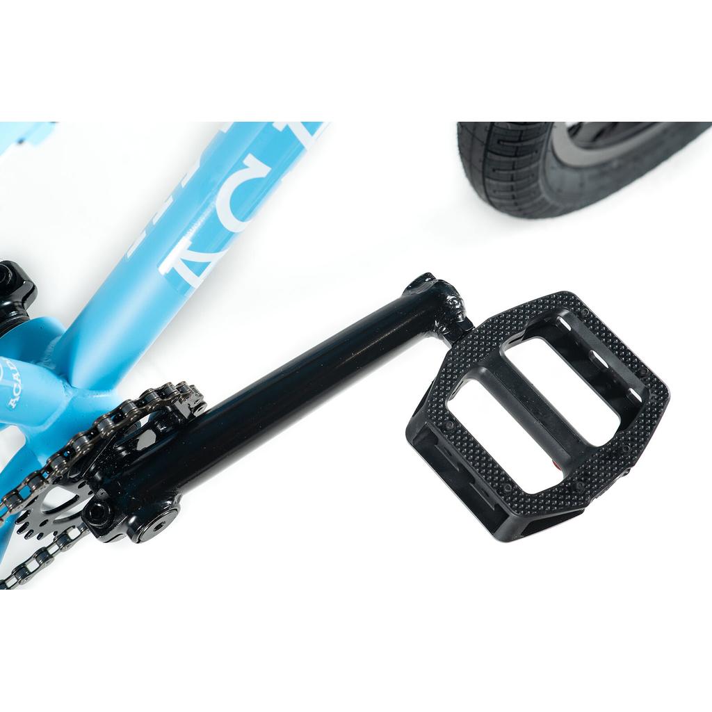 Close-up of a black pedal and crank arm attached to the blue Academy Trooper 20 Inch Bike frame, with part of the rear wheel visible.