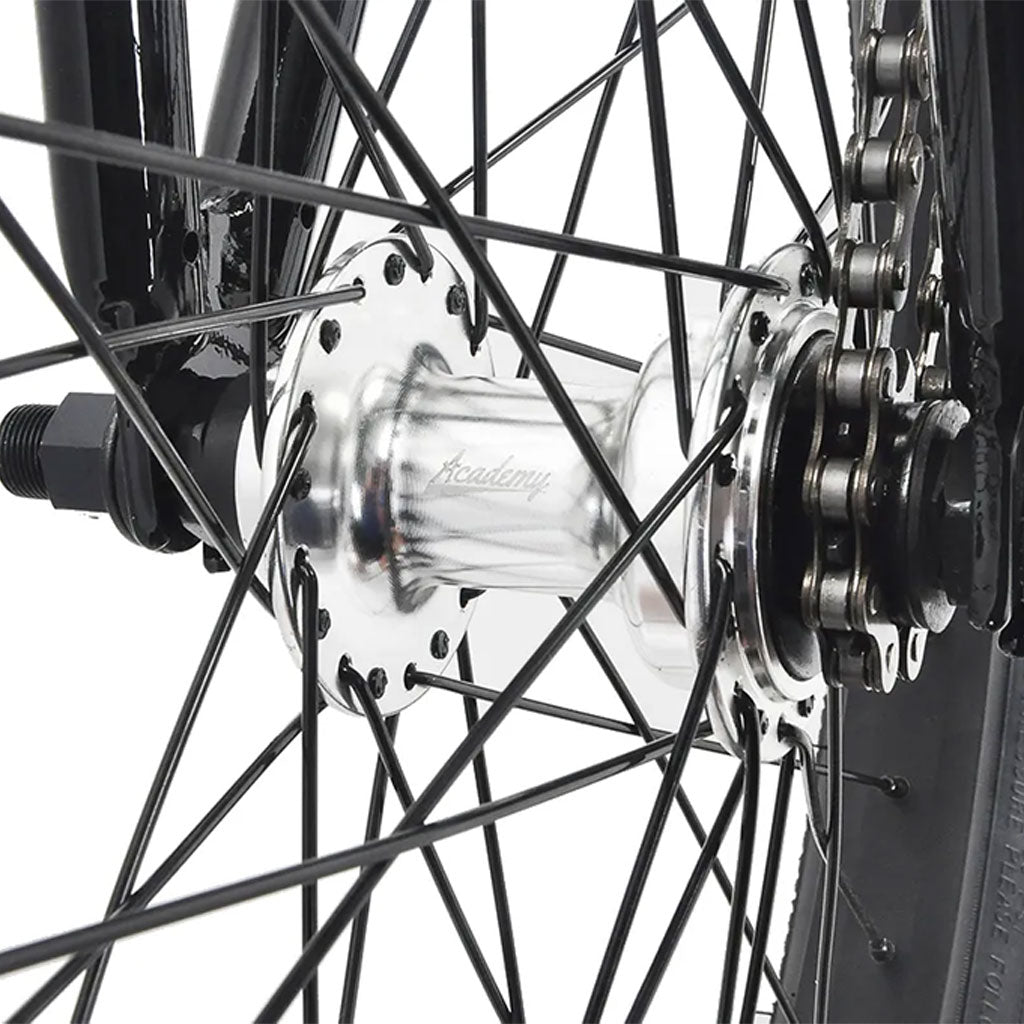 A close up of an Academy Trooper BMX bicycle wheel with a chain and spokes, featuring sealed mid bottom bracket.