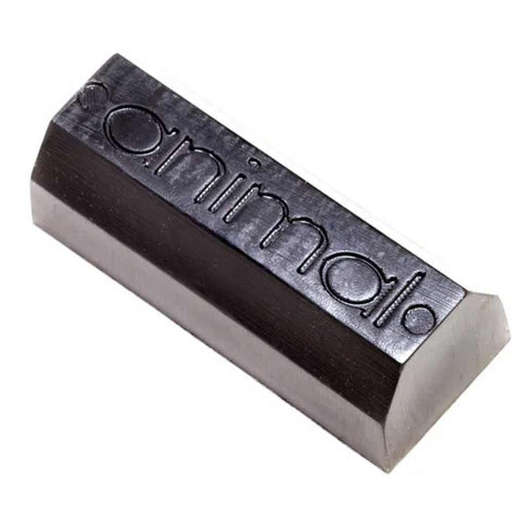 A bar of Animal Bump Jump Wax with the word "minimum" embossed on it, made in San Francisco, isolated on a white background.