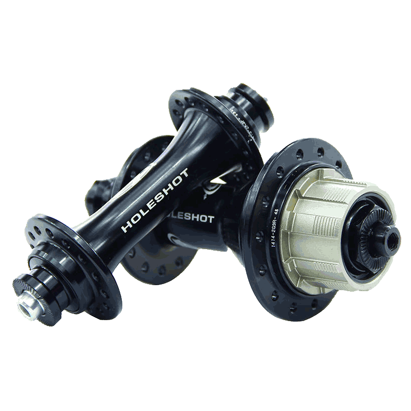 The Answer Holeshot Mini Hub Set 28H in black includes two hubs labeled "HOLESHOT," each with multiple spoke holes and a silver gear attachment. These cassette hubs are engineered with precision sealed bearings to ensure smooth performance.