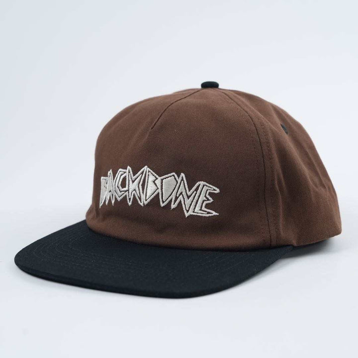 The Backbone Always Building Hat is an unstructured brown and black baseball cap with the "BACKBONE BMX" logo embroidered in white on the front.