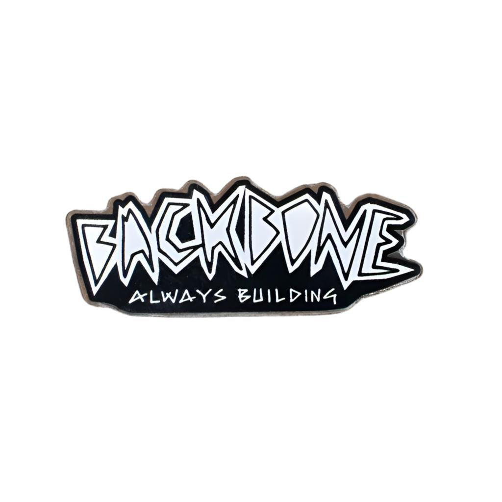 The Backbone Always Building Pin features stylized text with "BACKBONE" over "ALWAYS BUILDING." Perfect for pin collectors or softgoods enthusiasts, it symbolizes resilience and unyielding dedication.