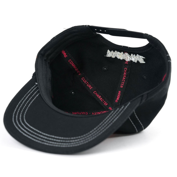 The Backbone Heart Logo 5 Panel Hat features a black design with white stitching and red text on the seams, "MAGMAWAVE" embroidered in white at the back, offering an Aussie BMX vibe ideal for style-conscious riders.