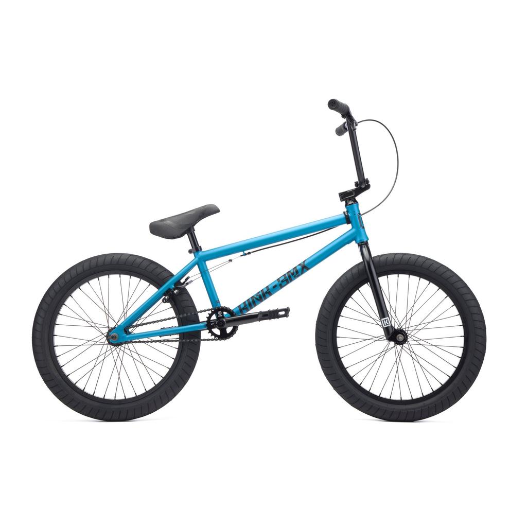 A blue Kink Launch 20 Inch Bike (2027) BMX with Mission parts, black tires, pedals, handlebars, and seat is shown in profile against a white background.