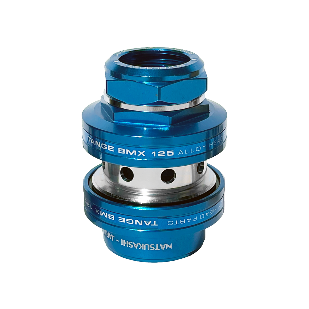 The Tange MX-125 Anodised Threaded Headset is a blue anodised alloy BMX headset with “TANGE BMX 125 ALLOY HEAD PARTS” and “NATSUKASHI-JAPAN” engraved on it, featuring an old school cylindrical design, a threaded top, and smooth sealed bearings for reliable performance.