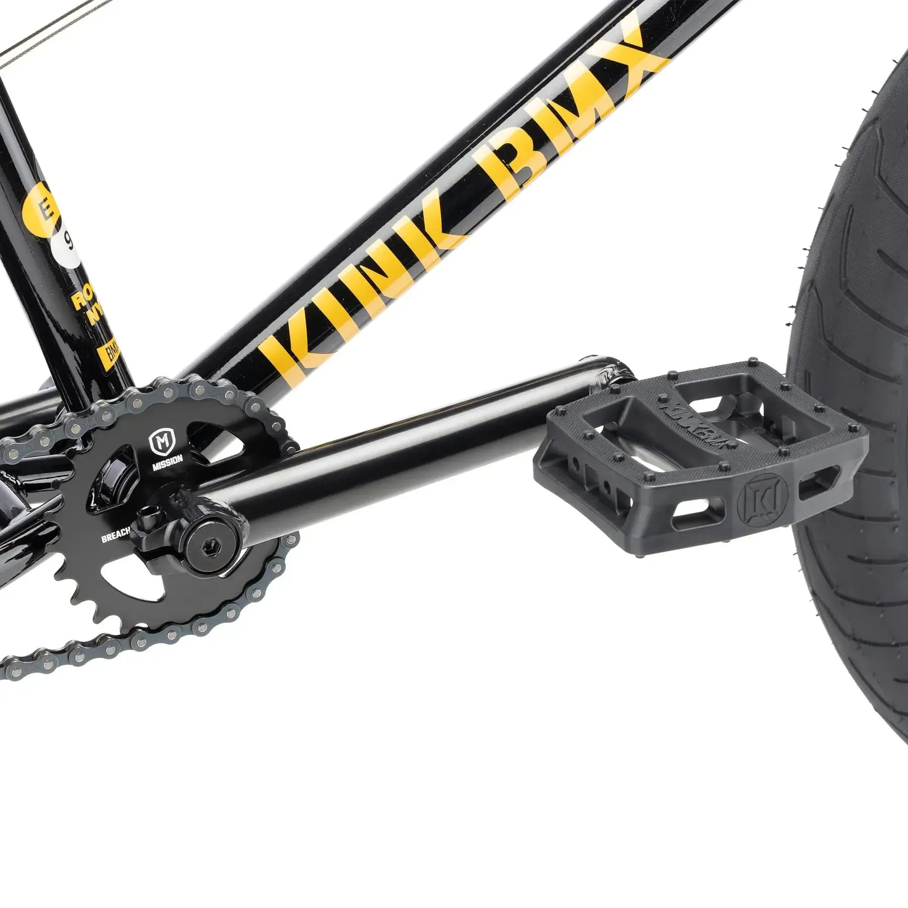 Close-up view of the pedal, crank, chainring, and rear wheel of a black Kink Gap XL 20 Inch Bike (2026) with yellow branding.