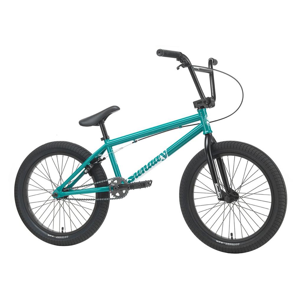 A Sunday Primer 20 Inch Bike in teal, featuring a black seat, black handlebars, and black tires, is shown from the side against a white background.