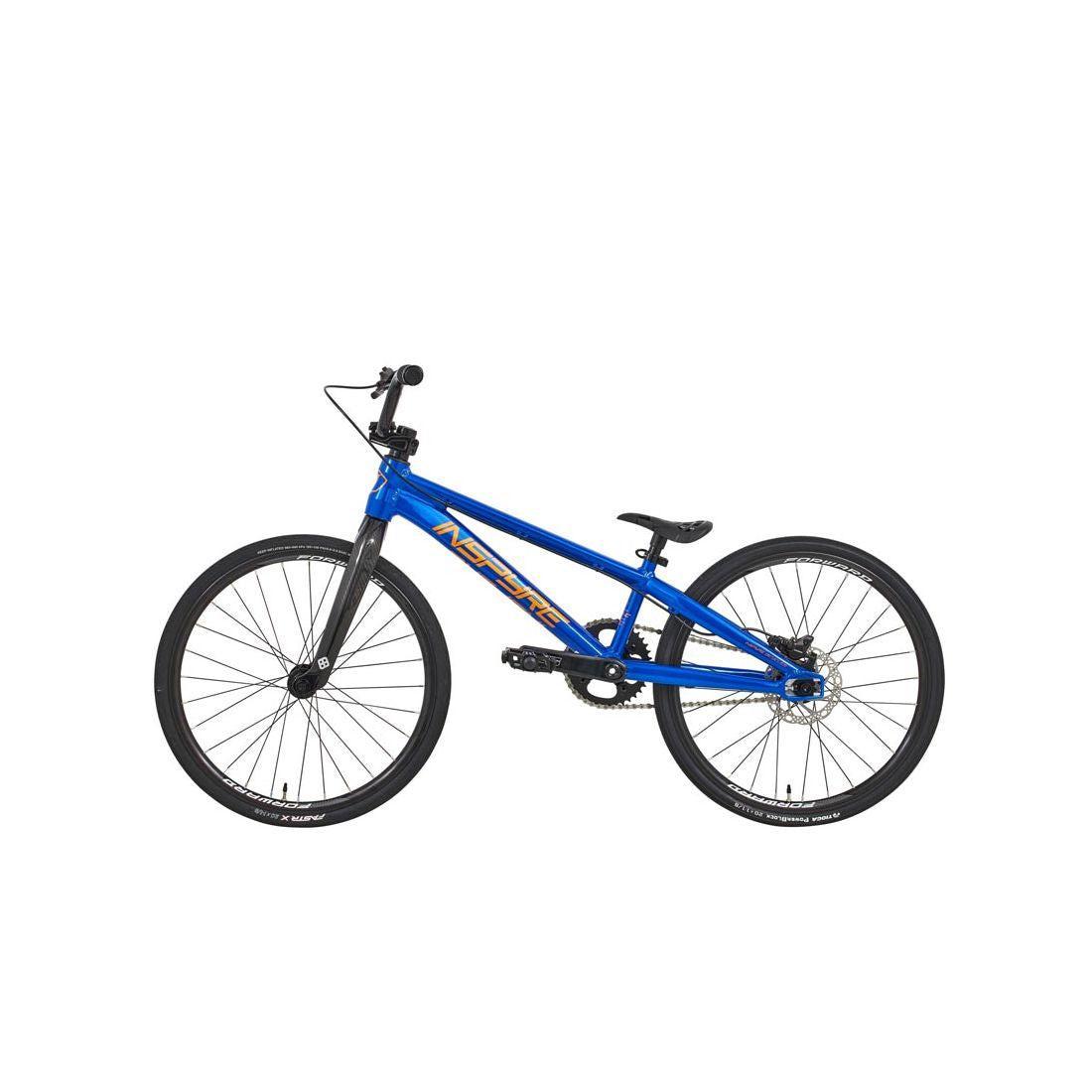 The Inspyre Evo-C Disc Junior Bike 2026 is shown in blue with black handlebars, seat, and wheels in a side profile view on a white background. It features Shimano hydraulic disc brakes for superior stopping power.