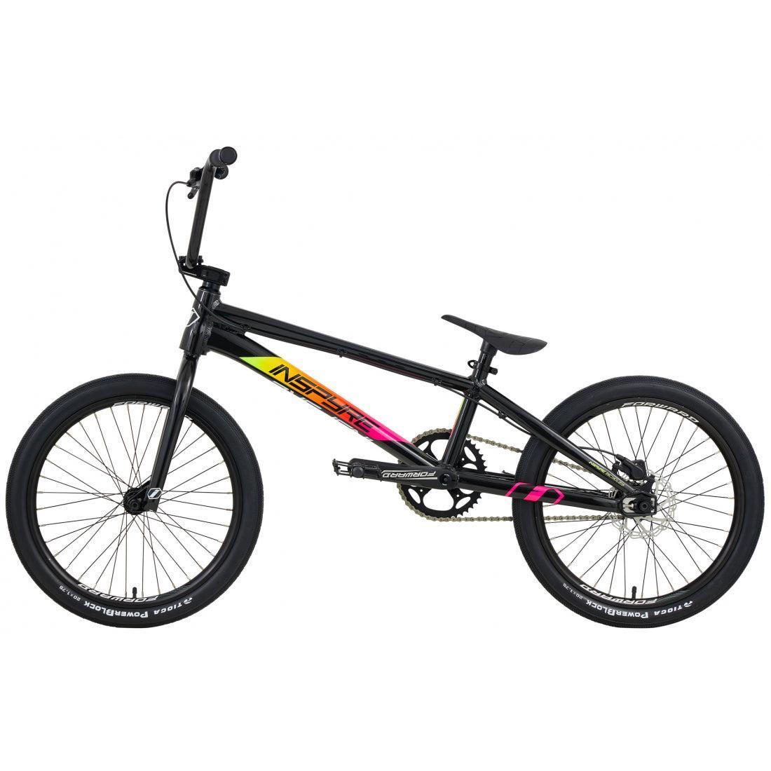 The Inspyre Evo Disc Pro L Bike 2026 in black with neon yellow and pink accents features a straight top tube, thick tires, hydraulic disc brakes, and flat pedals, shown in side profile on a white background.