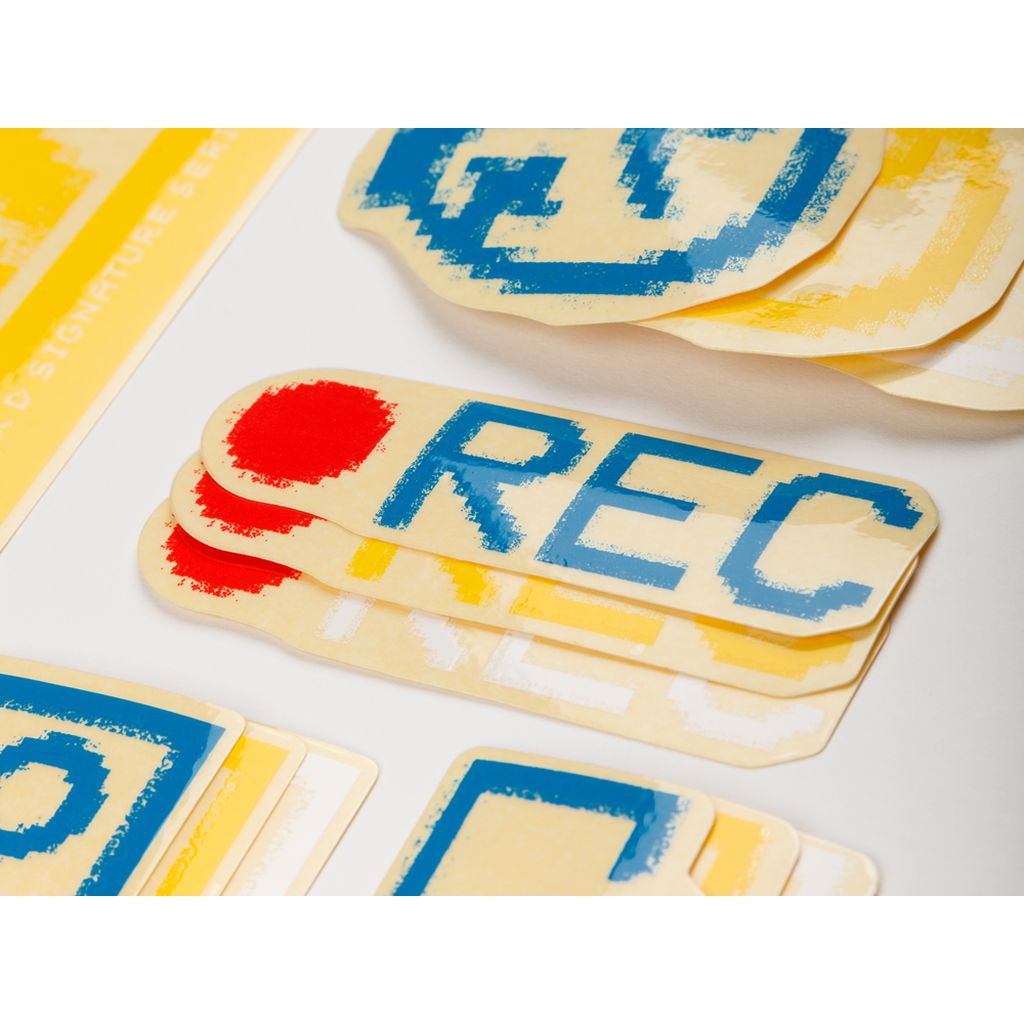 The BSD ALVX AF Frame 2019 Decal Set features assorted yellow and white stickers with text and graphics, including a prominent "REC" sticker with red and blue print—perfect for adding flair to your BSD or ALVX frame.