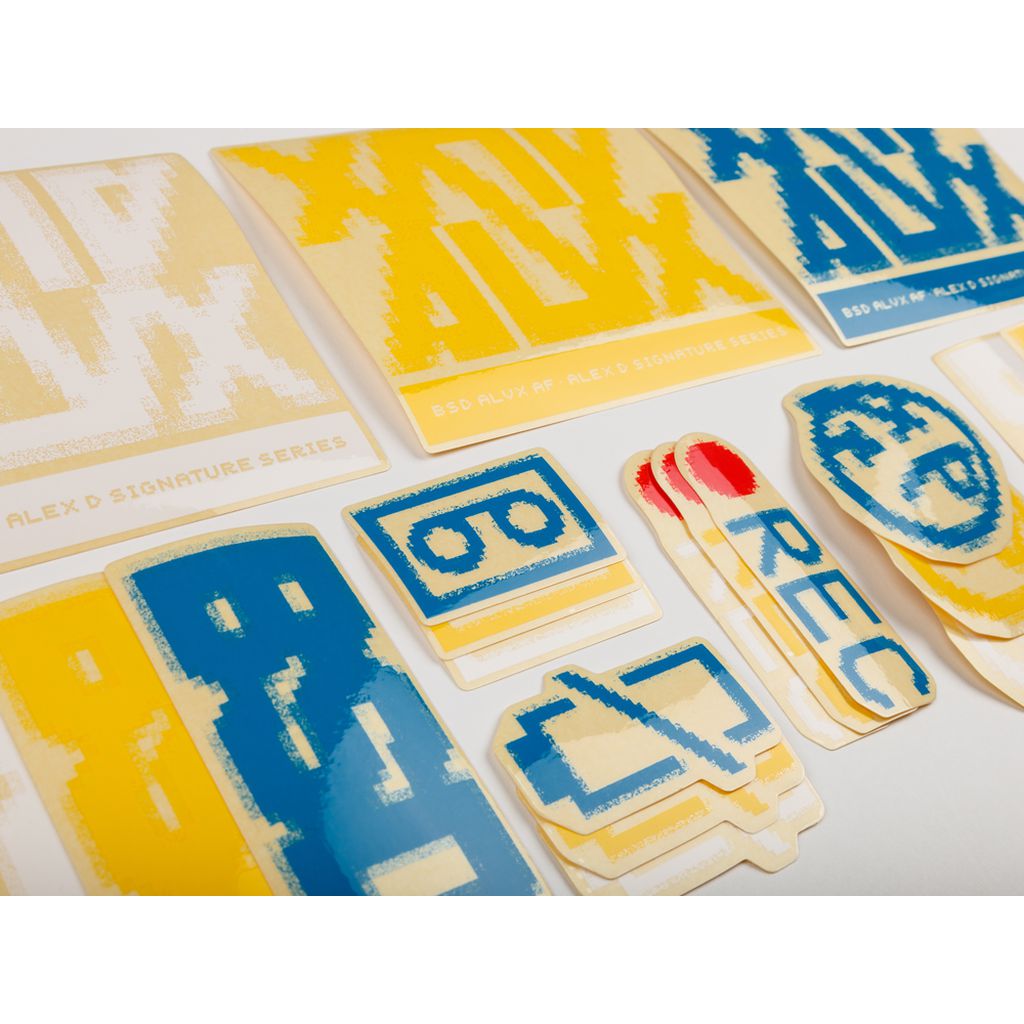 The BSD ALVX AF Frame 2019 Decal Set includes an array of pixelated stickers in blue and yellow hues on a white backdrop—perfect for any ALVX frame or as an enjoyable alternative sticker pack.