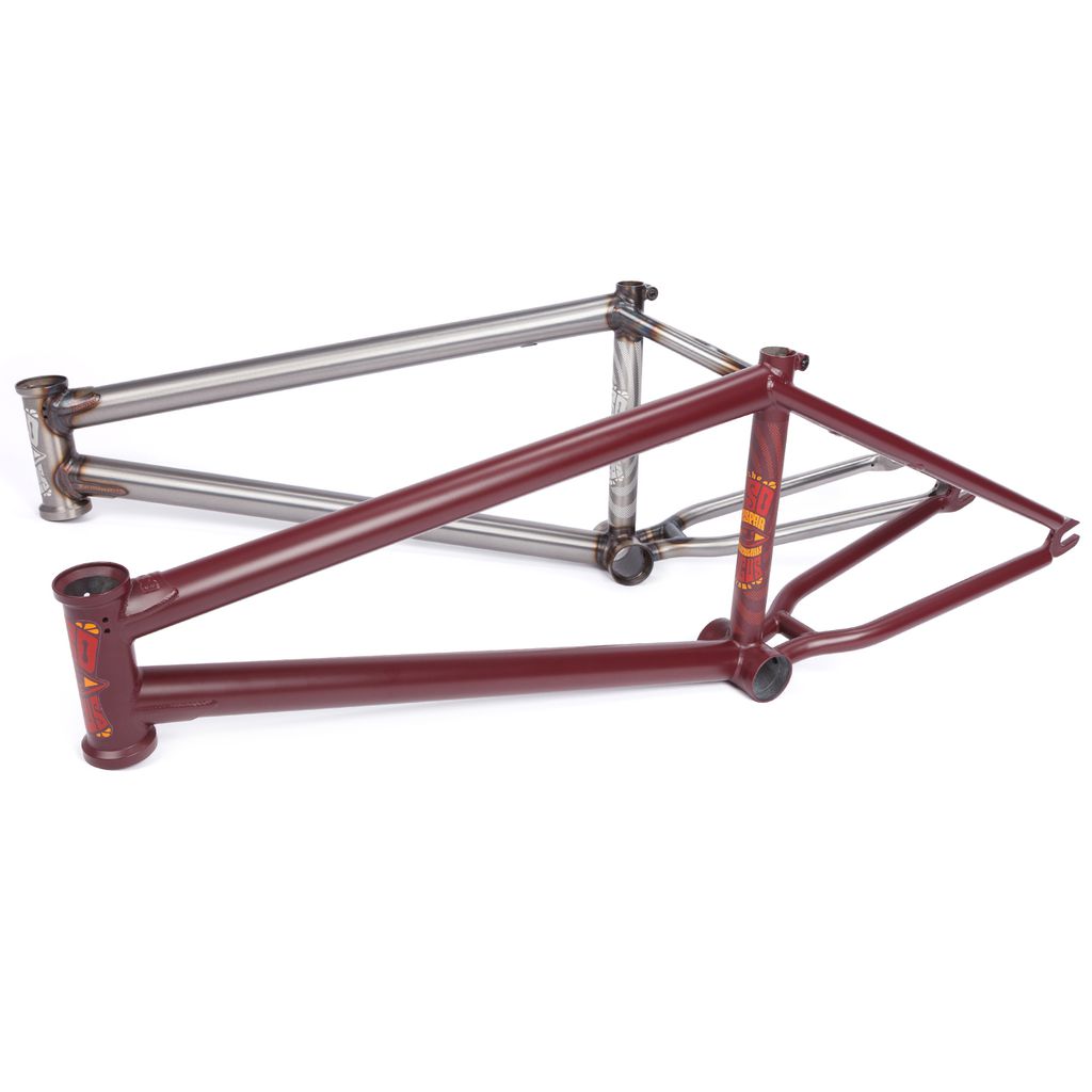 The BSD Focus Frame (Gaspar Guendulain) in maroon with yellow decals is shown next to a raw metal BMX frame, both placed side by side on a white background.