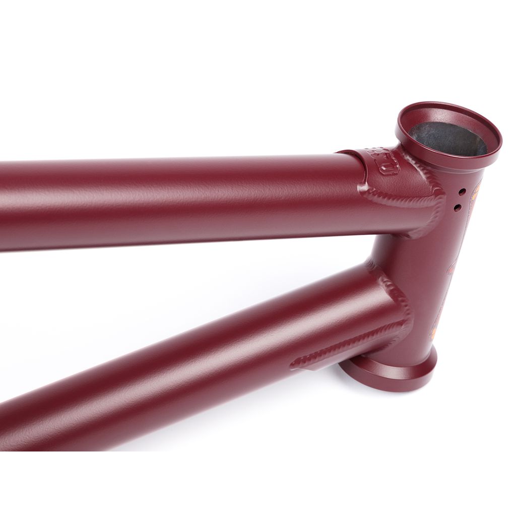 Close-up of the BSD Focus Frame (Gaspar Guendulain) in matte maroon, highlighting the welds at the top tube, down tube, and head tube junction—a signature BMX frame.
