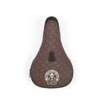 A brown BSD Grime (Denim Cox) Pivotal Seat with a logo on it, perfect for adding a touch of doubtless style to your speed-filled adventures.