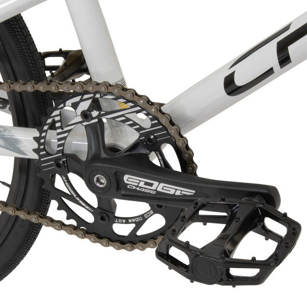 A close up of a Chase Edge Mini Bike (2024) with a chain and chainring.