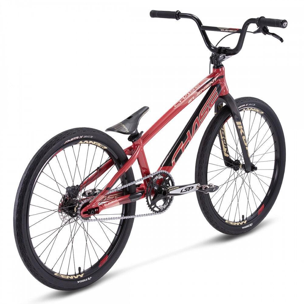 A Chase Element Pro+ Cruiser Bike with a red and black frame, featuring an angled seat, sturdy handlebars, Ikon carbon forks, thick tires, and a single-speed drivetrain.