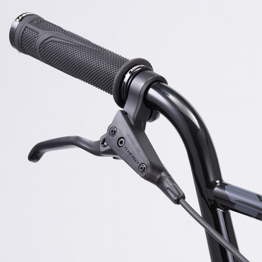 Close-up of the Chase Element Pro XL Bike's black handlebar with a textured grip, brake lever, and visible wiring against a plain background, showcasing its sleek design.