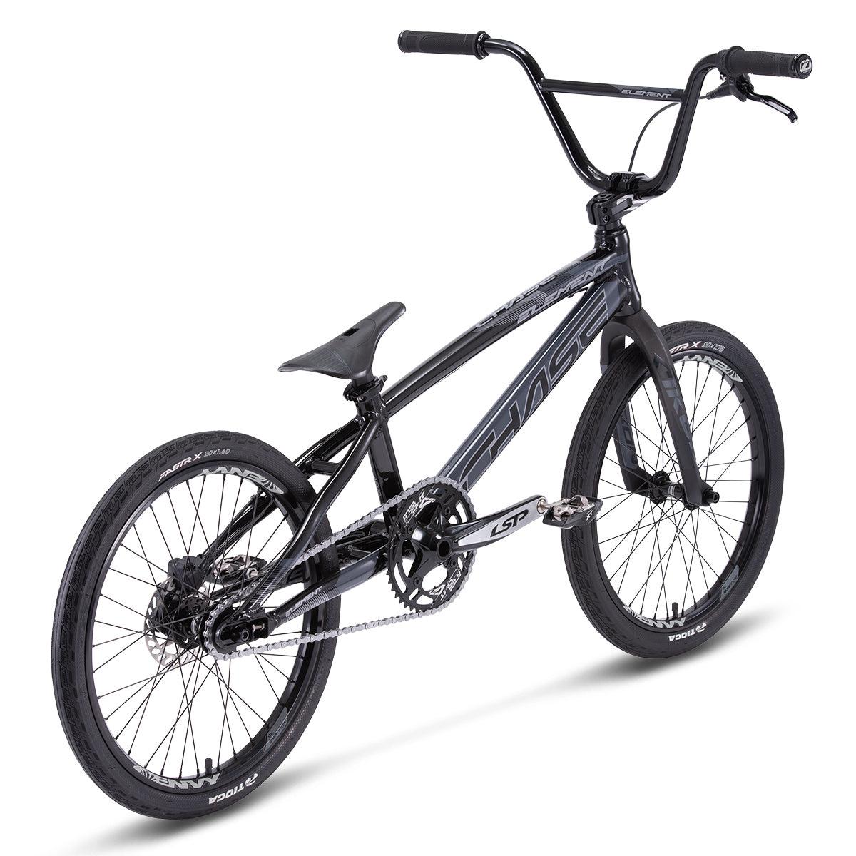 The Chase Element Pro L Bike is a black BMX race bike equipped with thick tires, a small seat, and a sturdy frame. It features Chase Element Ikon carbon forks, a single gear, chain drive, and high handlebars.