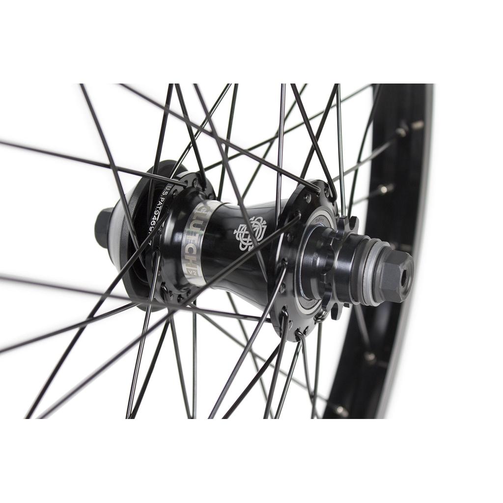 Close-up view of the Odyssey Clutch V2 X Hazard Lite Wheel in black, featuring metal spokes radiating outward and showcasing detailed components and nuts on this premium rear wheel.