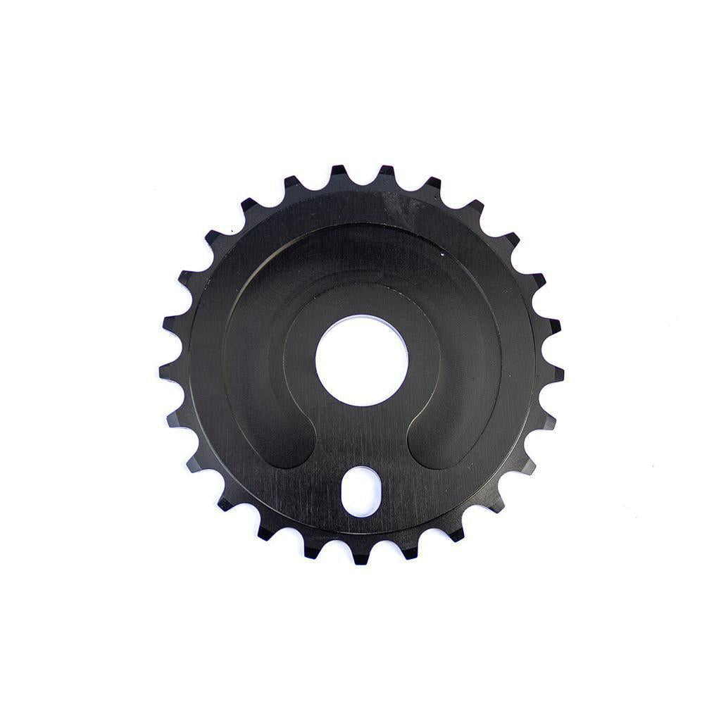 The limited edition Colony Beenleigh 40 Years CD Sprocket 25T boasts a sleek black design with a central hole and teeth around the edge, set against a white background. Inspired by the energy of Beenleigh Skatepark, it's ideal for riders seeking both performance and style.