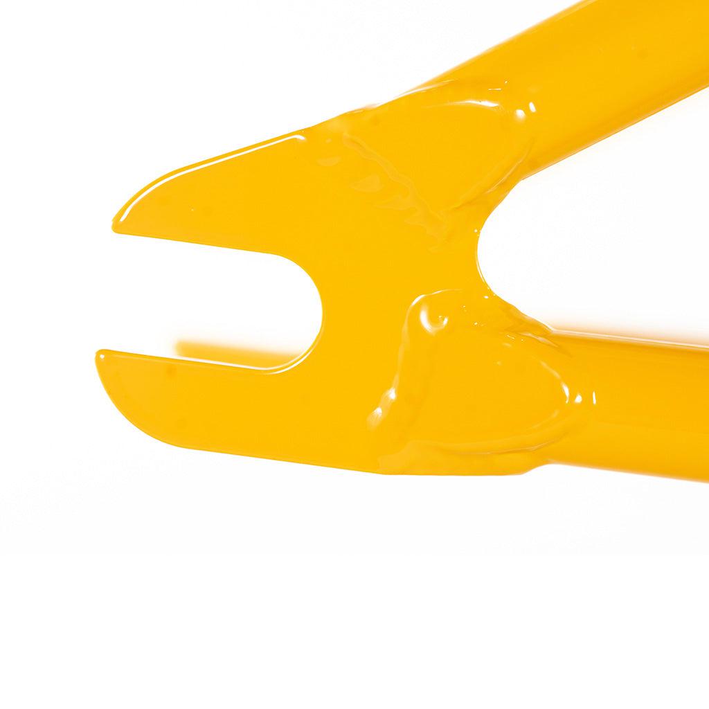 A yellow plastic Colony Enishi Flatland Frame (Kio Hayakawa Signature) on a white background, perfect for flatland riders.