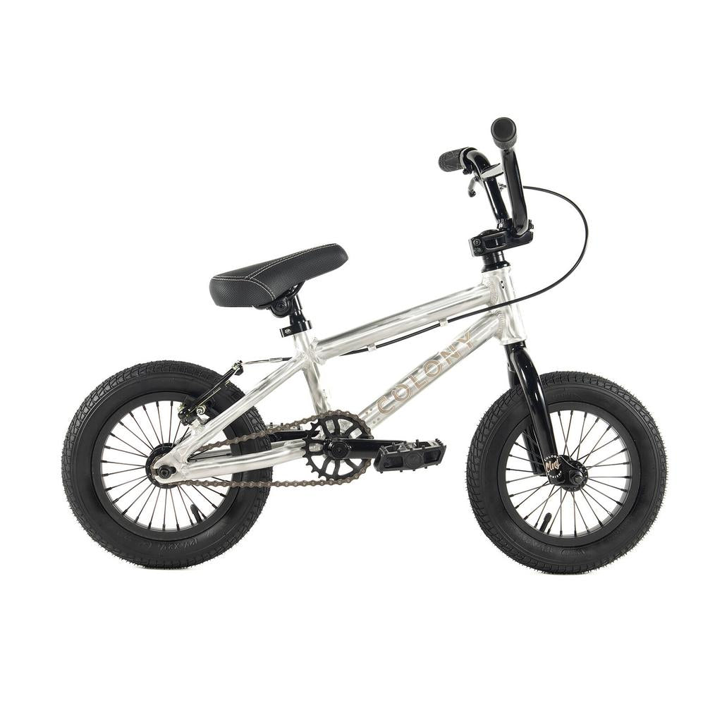A small, silver and black Colony Horizon 12 Inch Bike with thick tires, padded seat, front handlebars, chain-drive system, and a lightweight alloy frame for easy handling sits on a white background.
