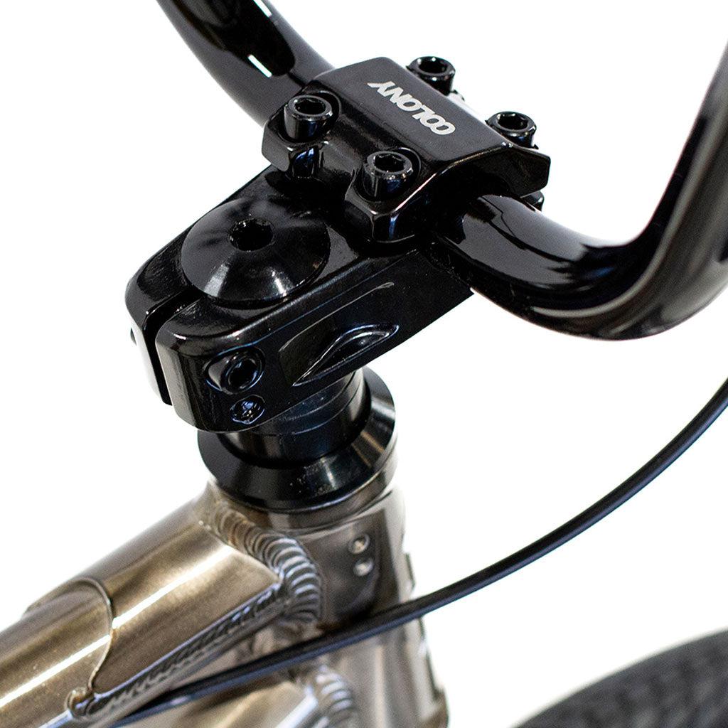Close-up view of the Colony Horizon 20 Inch Bike’s handlebar stem and headset, highlighting detailed welds on the lightweight alloy frame and a "COLONY" logo on the stem, with cables running along the front.