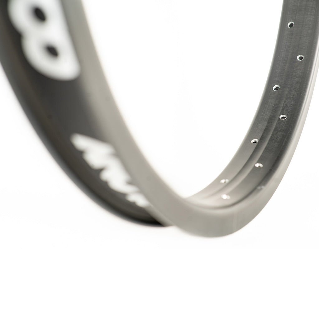 Close-up of a Colony Pintour 18 Inch Rim with evenly spaced spoke holes on a plain white background, perfect for budget-conscious riders seeking durability and style.