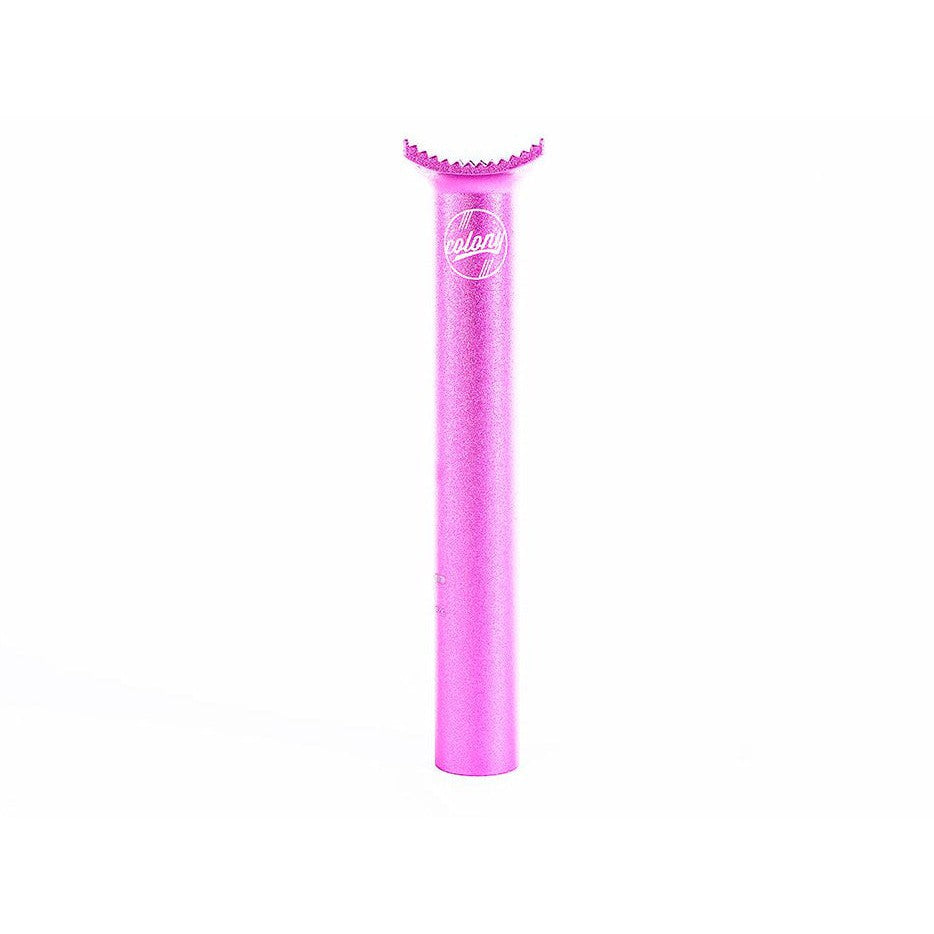 The Colony Pivotal Seat Post (185mm) is a metallic pink stump style seatpost with a notched top, "colony" branding near the top, and Pivotal technology for secure saddle adjustment.