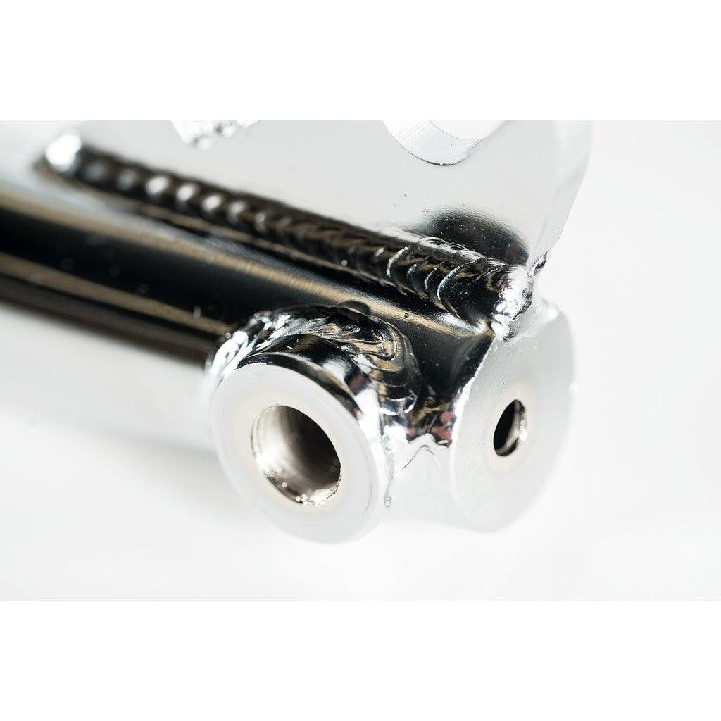 Close-up of the Colony Prody Fork (Brake Mounts), showcasing its shiny metal component with precise welding details, two cylindrical holes, and expertly crafted peg bosses.