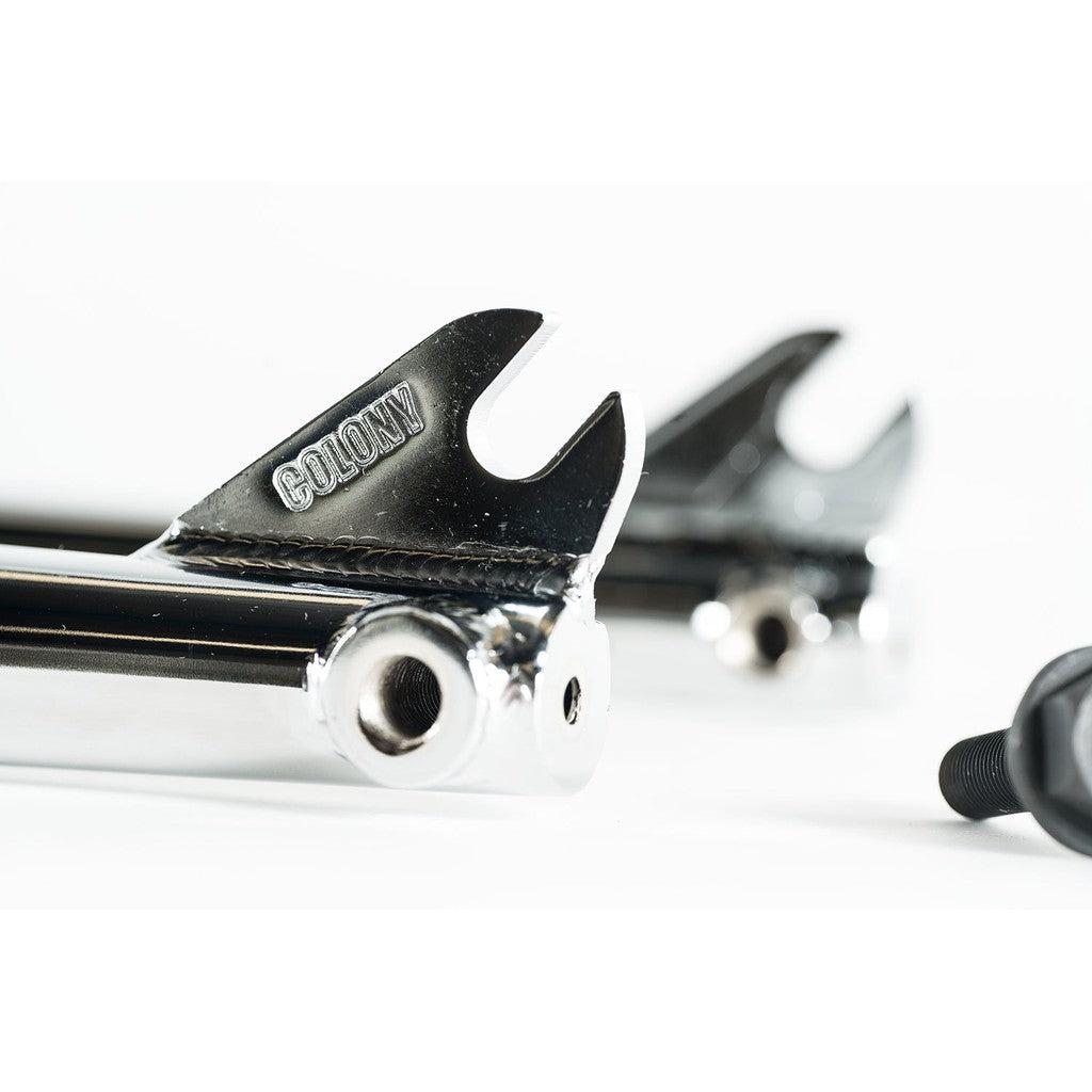 Close-up of chrome Colony Prody Fork with "COLONY" engraved, highlighting detailed welds, peg bosses, and brake mounts.