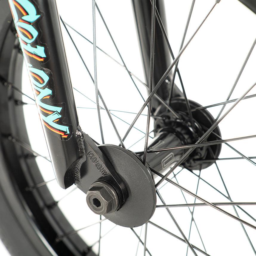 Close-up of a bicycle wheel with black spokes, showcasing a hub and axle nut. The vibrant Sweet Tooth Pro Elite logo adorns the fork, capturing the essence of this 16 Inch BMX bike.