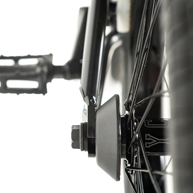 Close-up of a Colony Sweet Tooth Pro Elite 16 Inch Bike rear wheel, highlighting the hub, spokes, and pedal crank with a visible metal bracket and nut.