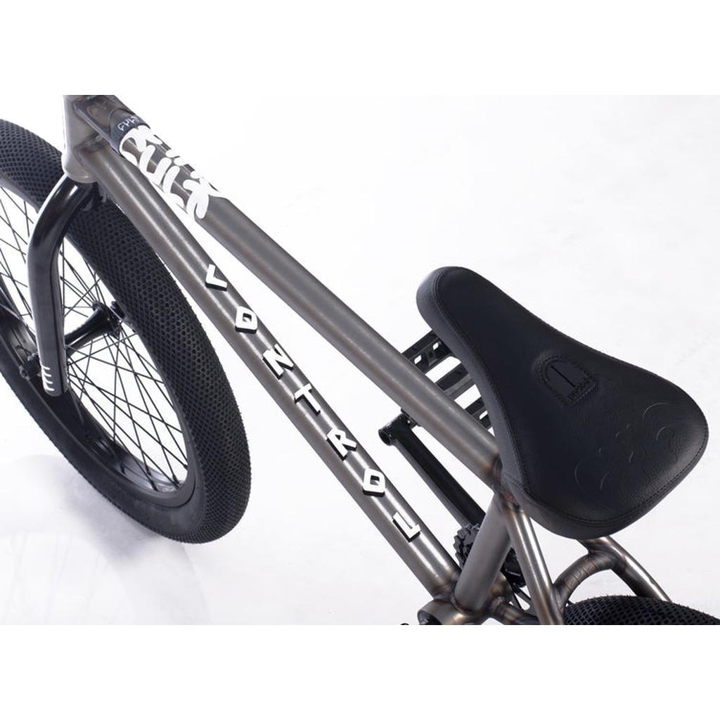 Close-up view of a Cult Control 20 Inch Bike, featuring the rear wheel, black padded seat, and metallic frame on a white background.