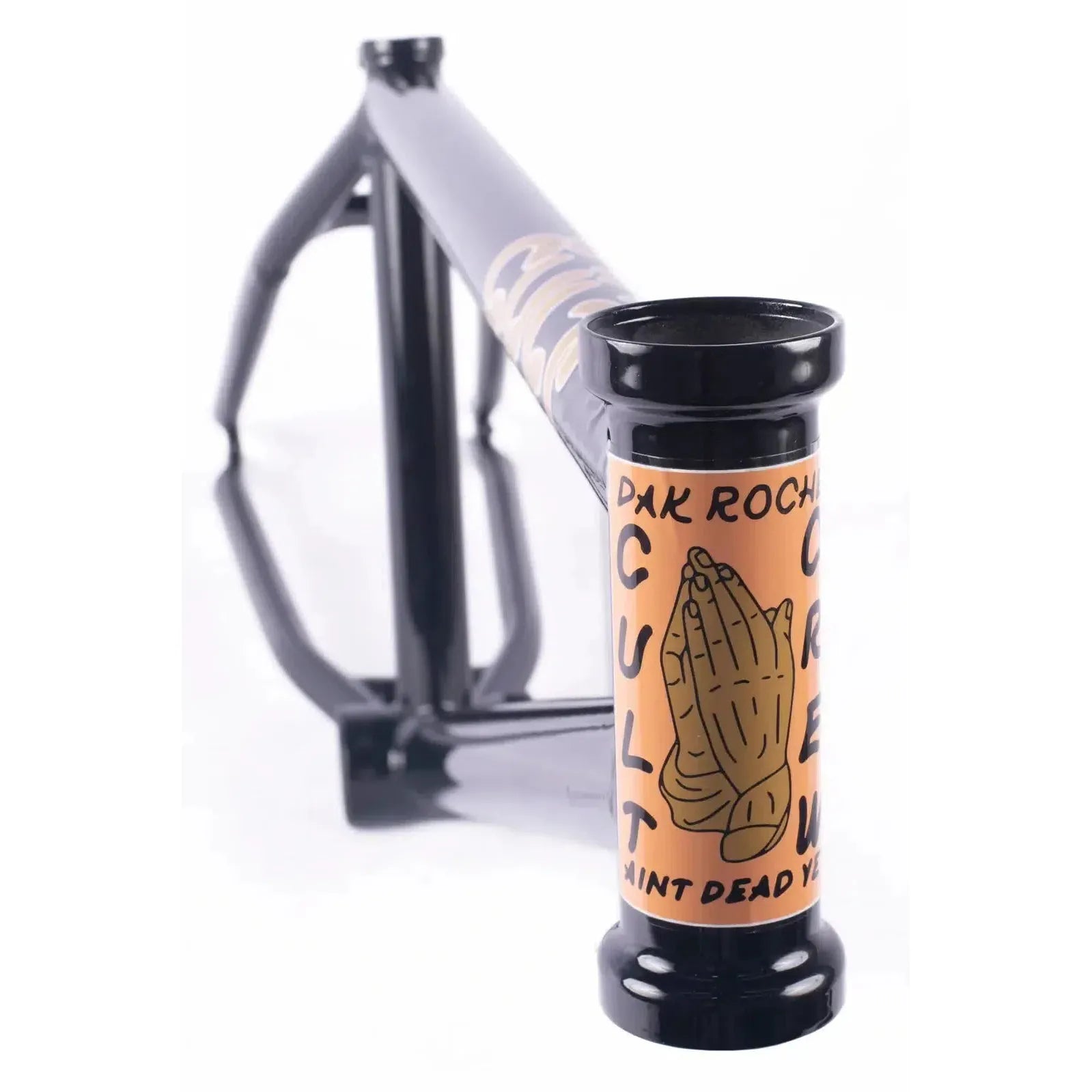 The Cult Dak Frame features a sleek black design with a beige head tube, adorned with praying hands and "CULT DAK ROCHE" text. Made from Cult Classic Tubing, it embodies Dakota Roche's signature style.